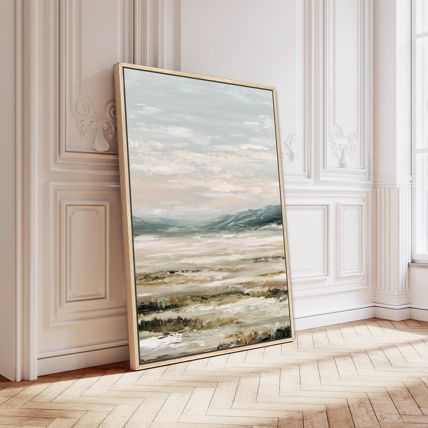 a large landscape painting displayed on a white wall in a room with a wooden floor.