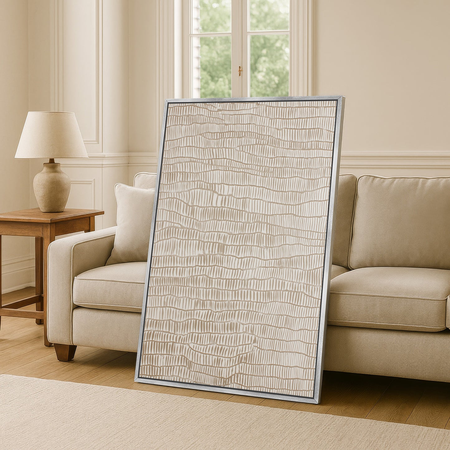 a large, rectangular, beige-colored artwork or painting displayed on a wall in a living room setting.