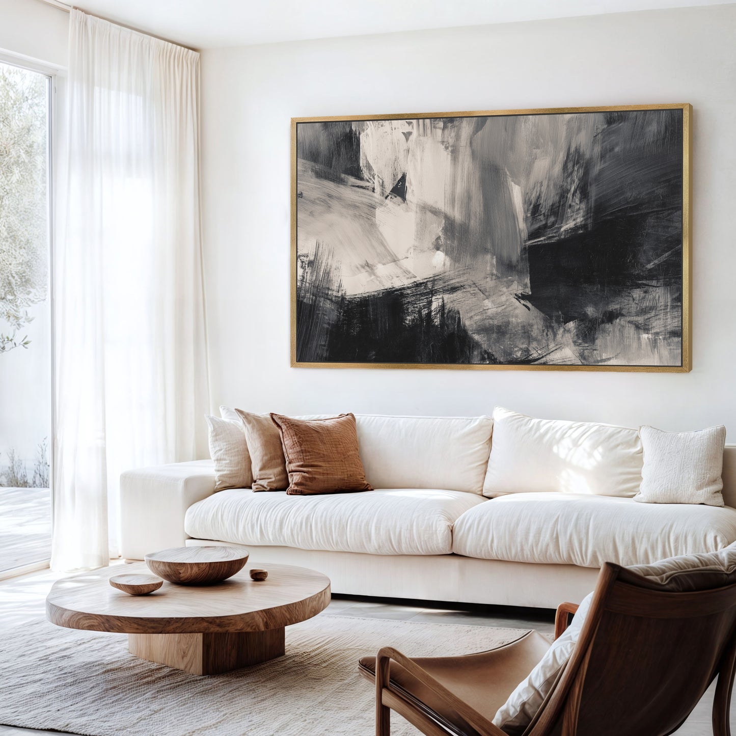 a modern living room with a large abstract painting on the wall, a white sofa, a wooden coffee table, and a brown leather armchair.