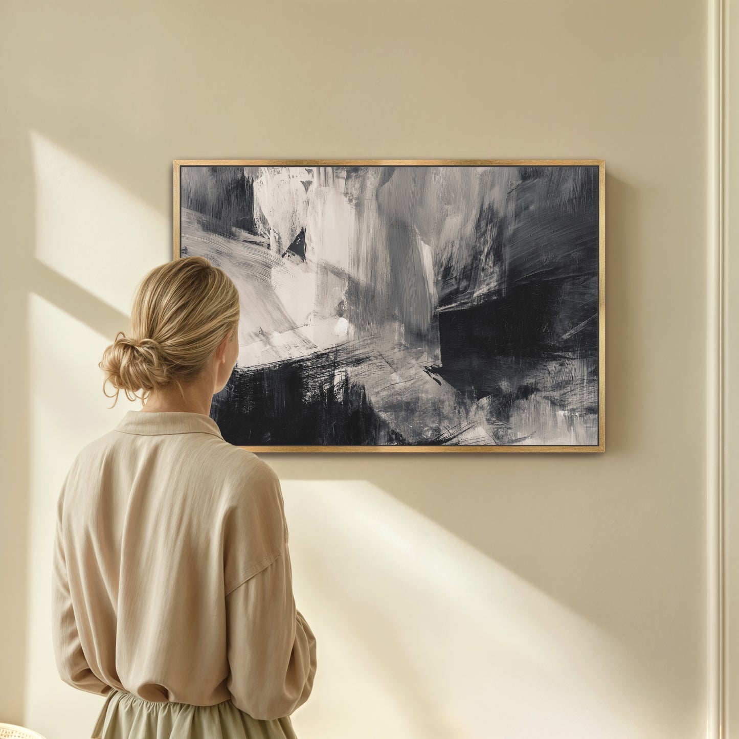 A woman stands in front of a large abstract painting, gazing at it with interest.