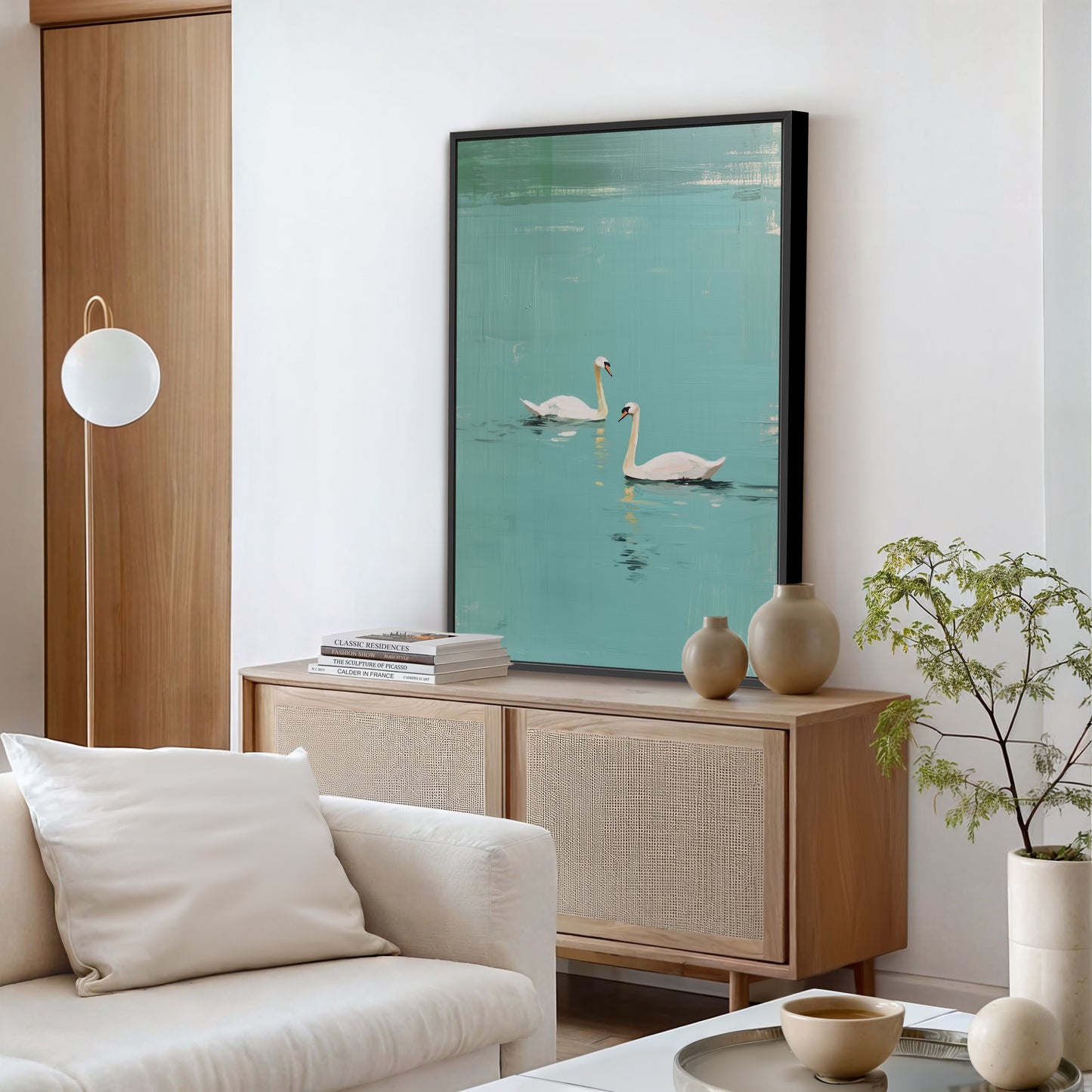 Large Evara swan lake artwork hung on modern living room wall.