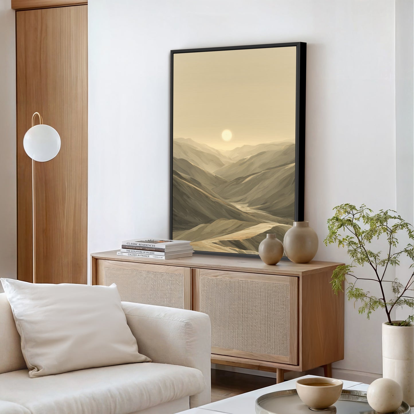 A modern living room console with a black framed canvas sitting on top.