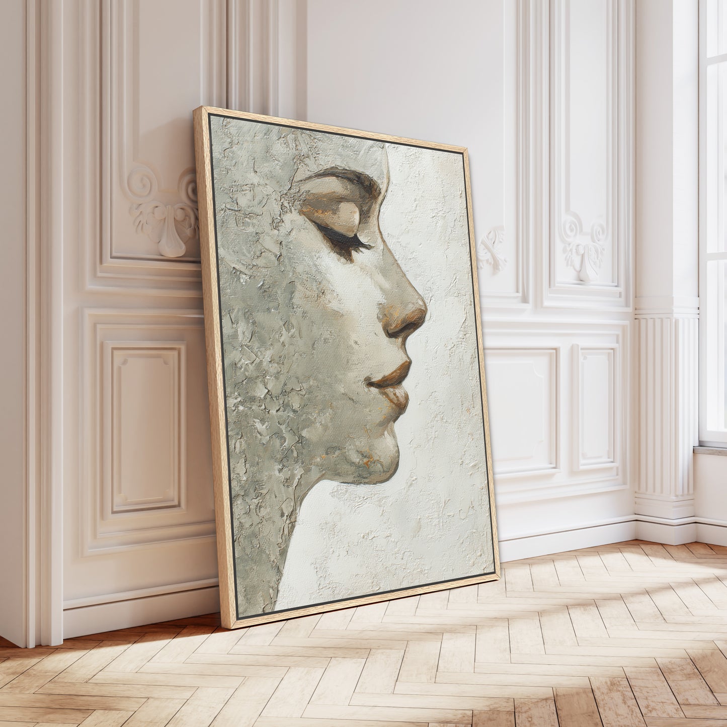 Oak-framed minimalist portrait leaning against white ornate Parisian wall in bright natural light interior.