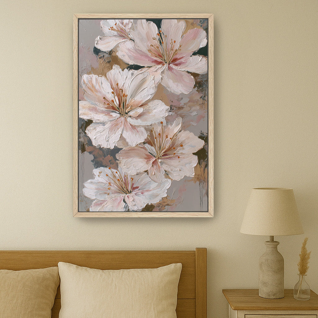 Large floral print featuring ivory and blush lilies framed in light oak, styled above a neutral beige bed.