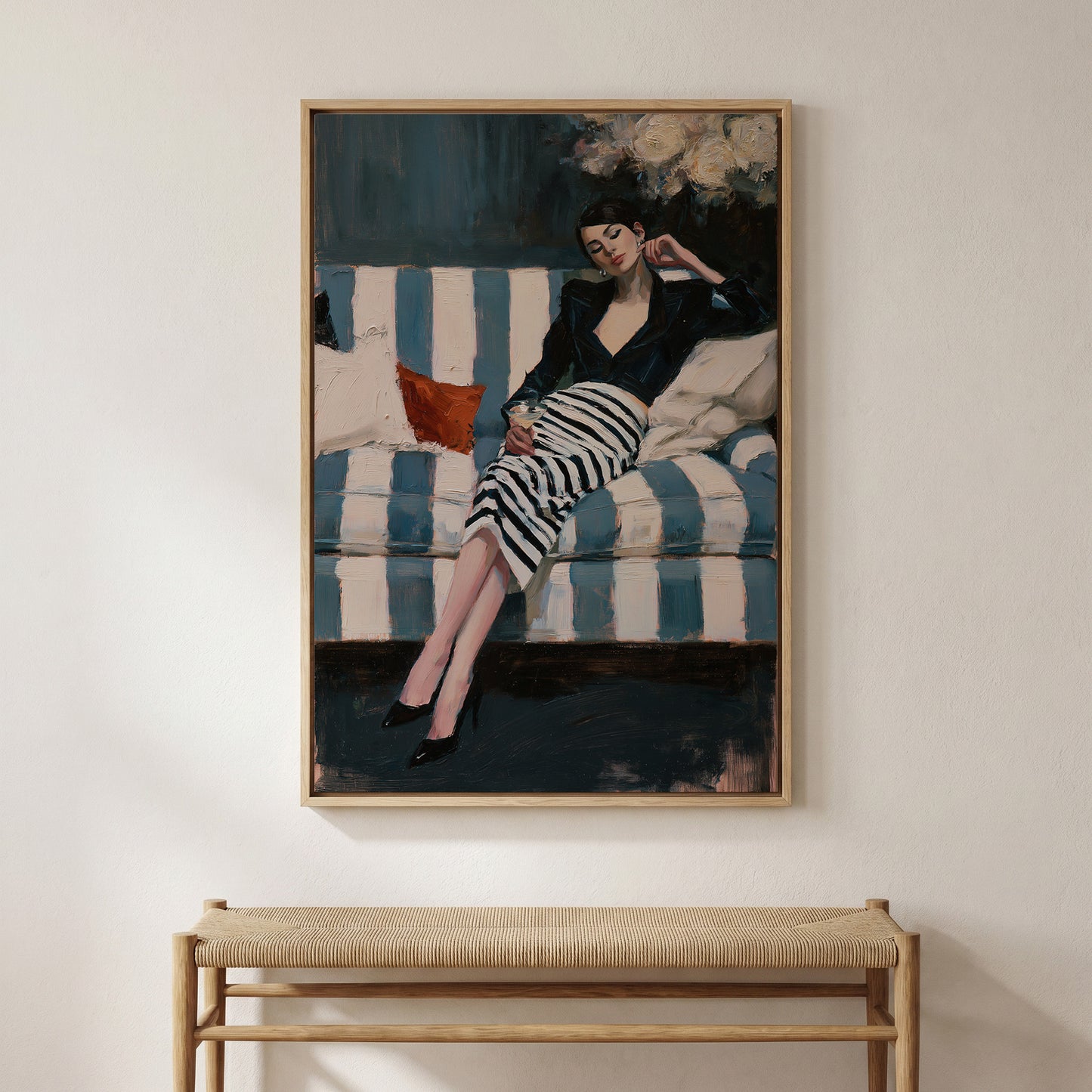 The image is a framed painting depicting a woman in a black and white striped dress sitting on a striped couch, with a red pillow on the couch.
