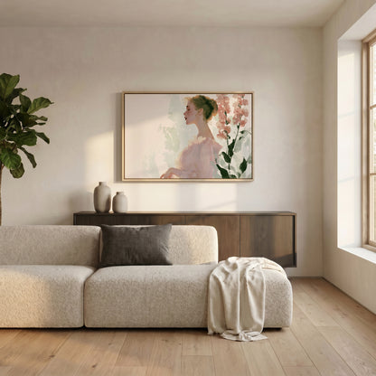 a serene living room with a large, framed painting of a woman's profile hanging on the wall above a beige sofa. The sofa is adorned with a gray throw pillow and a white blanket, creating a cozy and inviting atmosphere. The room is further enhanced by the presence of a potted plant and a wooden cabinet, adding to the overall aesthetic and comfort of the space.
