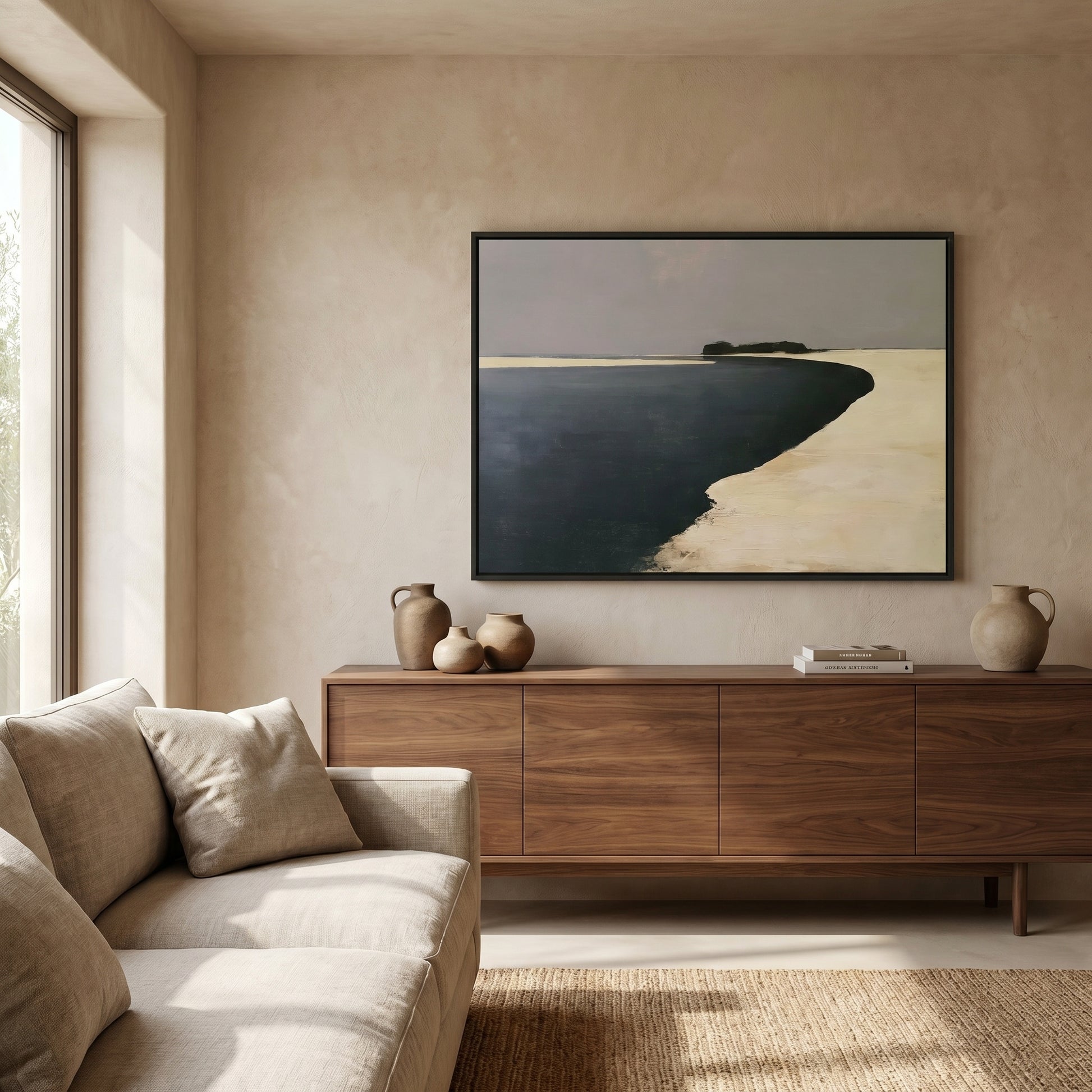 a serene living room with a large window, a wooden dresser, a beige sofa, and a framed landscape painting on the wall.