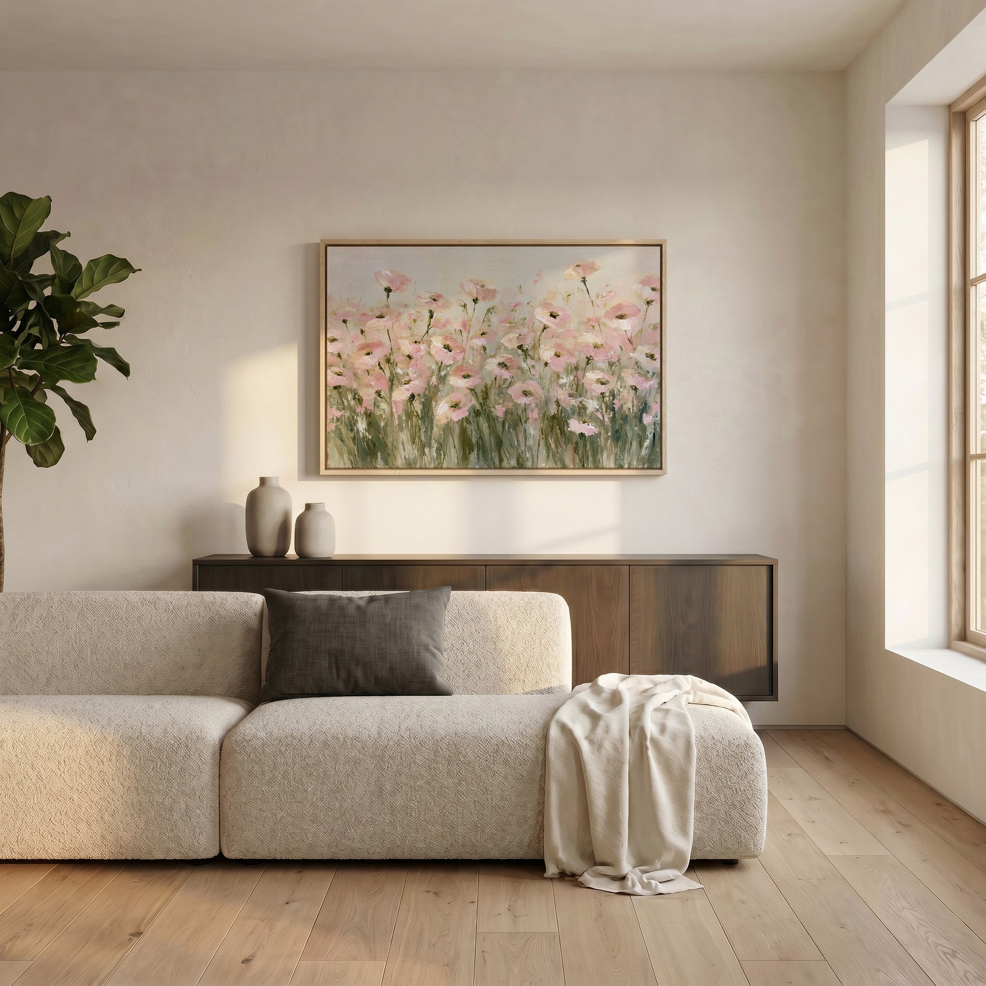 a serene living room with a large window, a beige sofa, a wooden cabinet, and a framed painting of pink flowers on the wall.