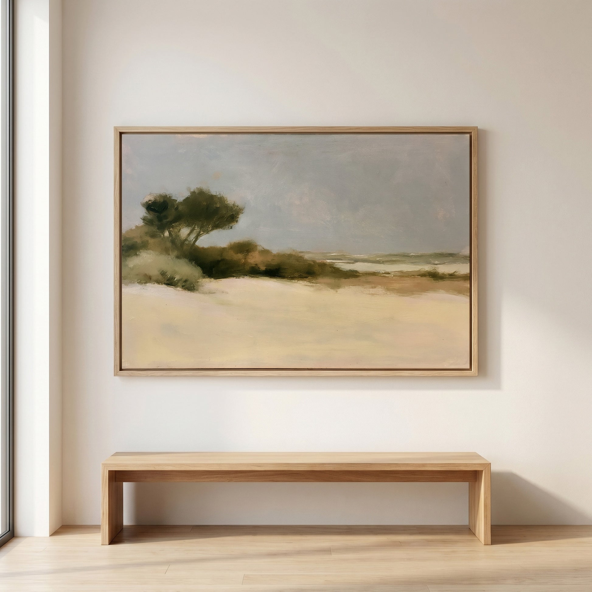 a large landscape painting hanging on a white wall above a wooden bench.