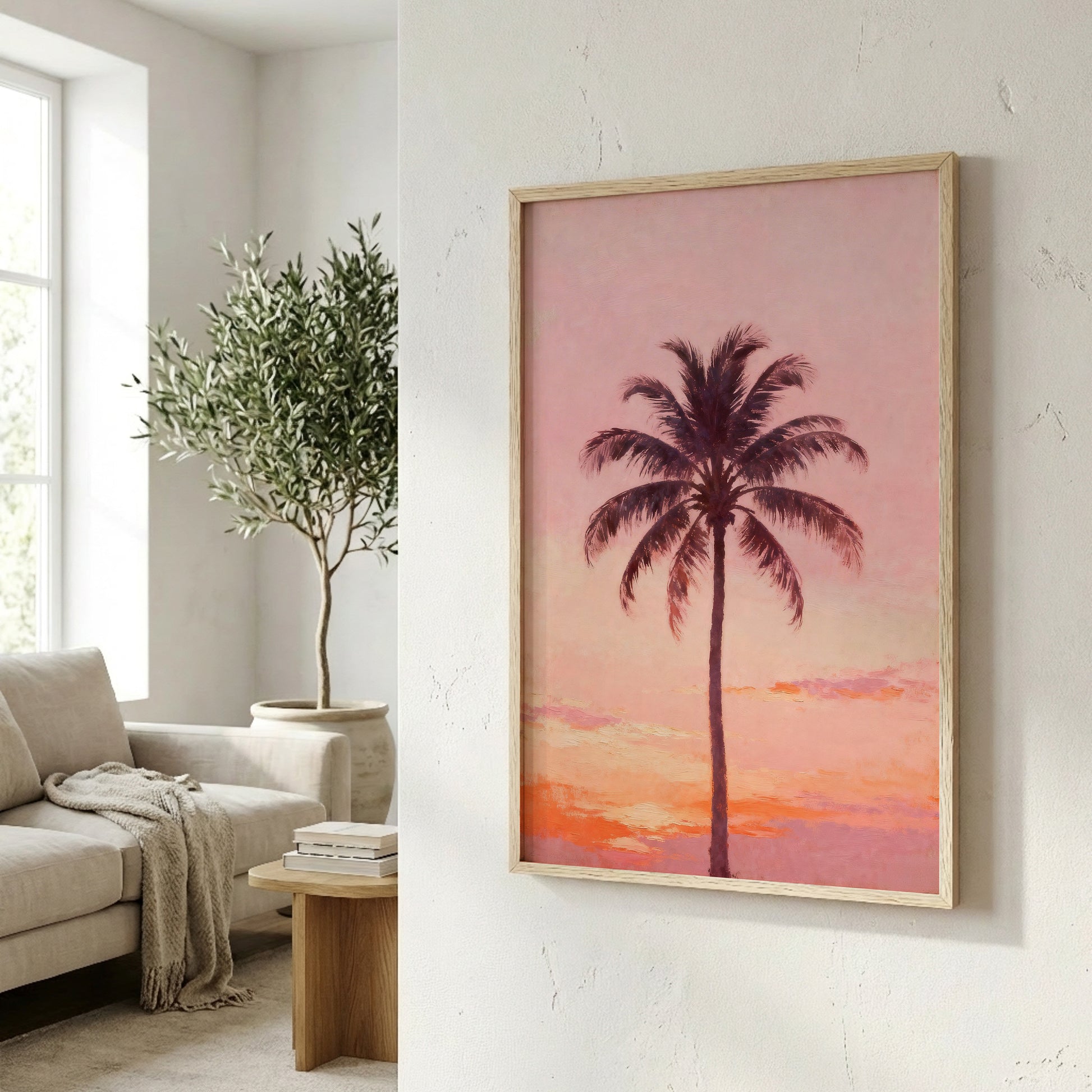 a framed painting of a palm tree against a sunset sky, hanging on a wall in a living room.