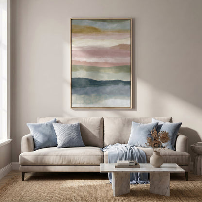 a living room with a beige sofa, a white coffee table, and a framed abstract painting hanging on the wall above the sofa.