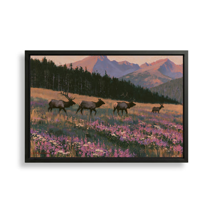 A framed painting depicting a group of elk walking through a field of wildflowers, with mountains in the background.