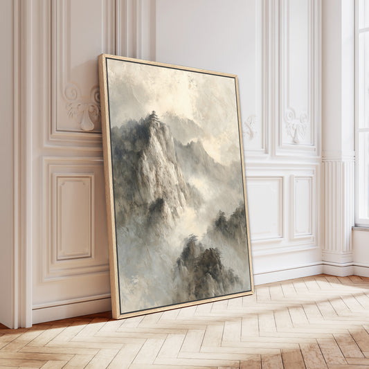 a large, framed painting of a mountainous landscape, leaning against a white wall in a room with a wooden floor.
