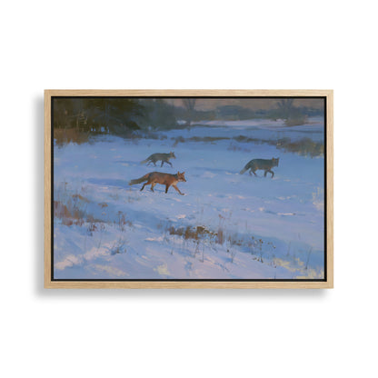 three foxes walking through a snowy field.