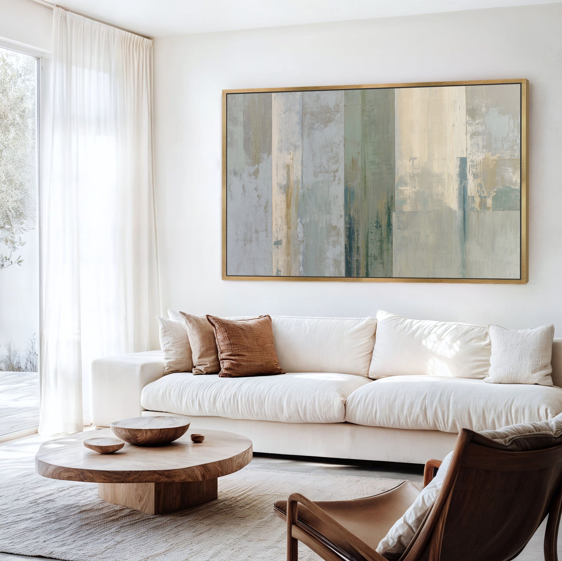 a modern living room with a large abstract painting on the wall, a white sofa, a wooden coffee table, and a brown leather armchair.