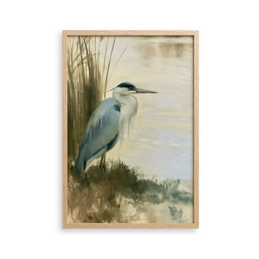 A blue heron standing on the bank of a body of water, surrounded by tall grasses.