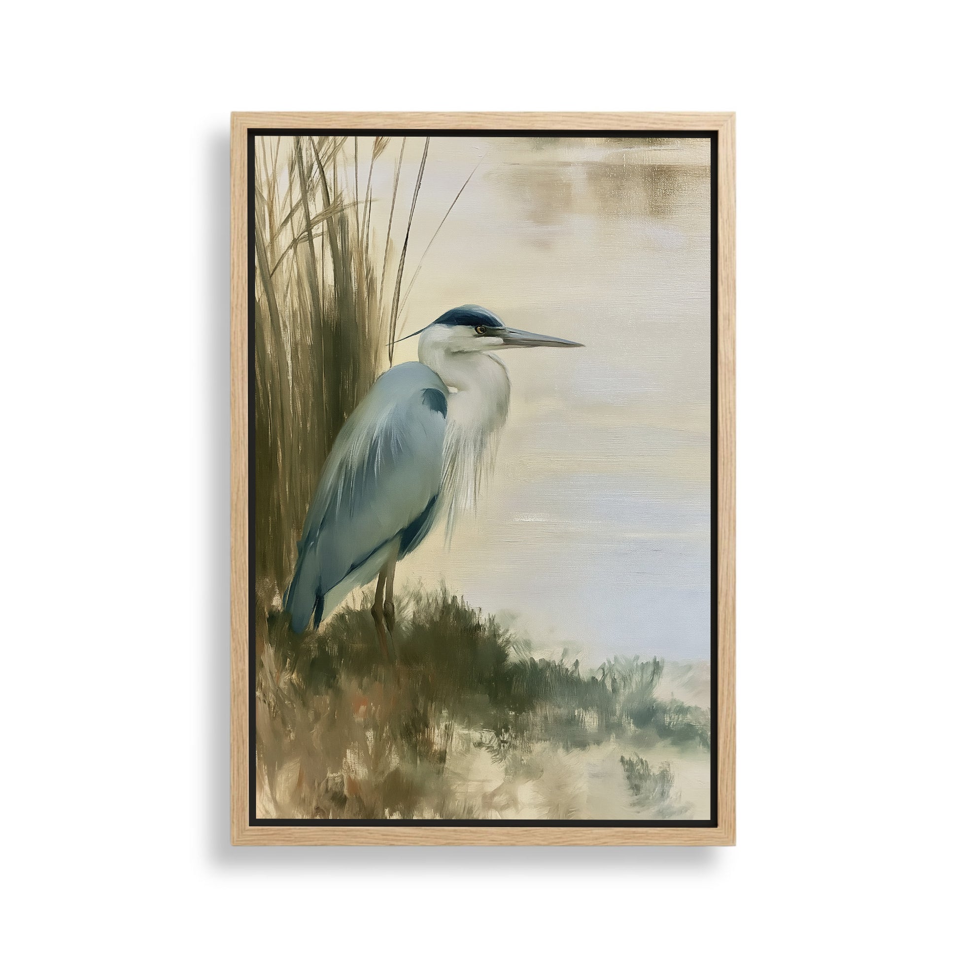 A blue heron standing on the bank of a body of water, surrounded by tall grasses.