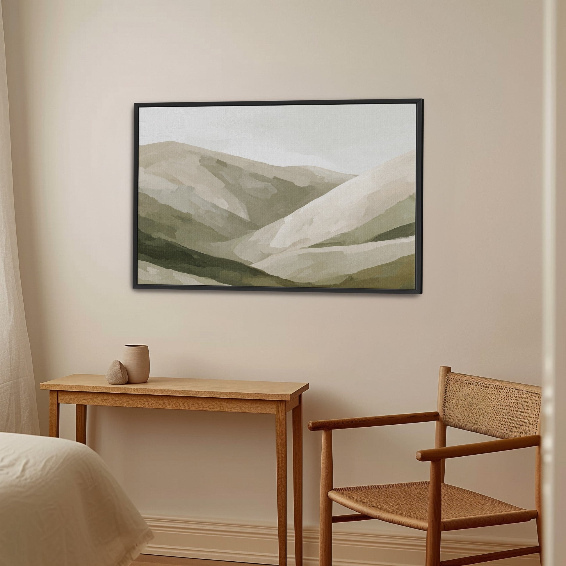 Olive Hills canvas print featuring layered olive, taupe, and sand hills in a black frame above a wooden desk and chair in a neutral modern room