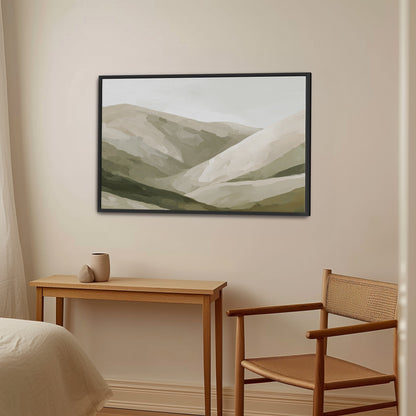 Olive Hills canvas print featuring layered olive, taupe, and sand hills in a black frame above a wooden desk and chair in a neutral modern room