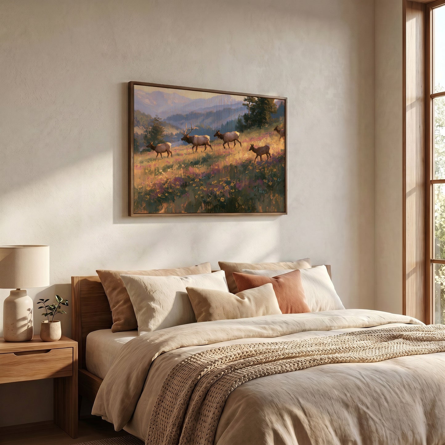 a serene bedroom scene with a large bed, a nightstand, and a framed painting of a group of elk in a field.