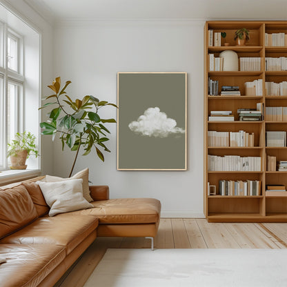 Trace Canvas Print depicting a single white cloud on muted sage background in a modern living room with leather sofa and bookshelf
