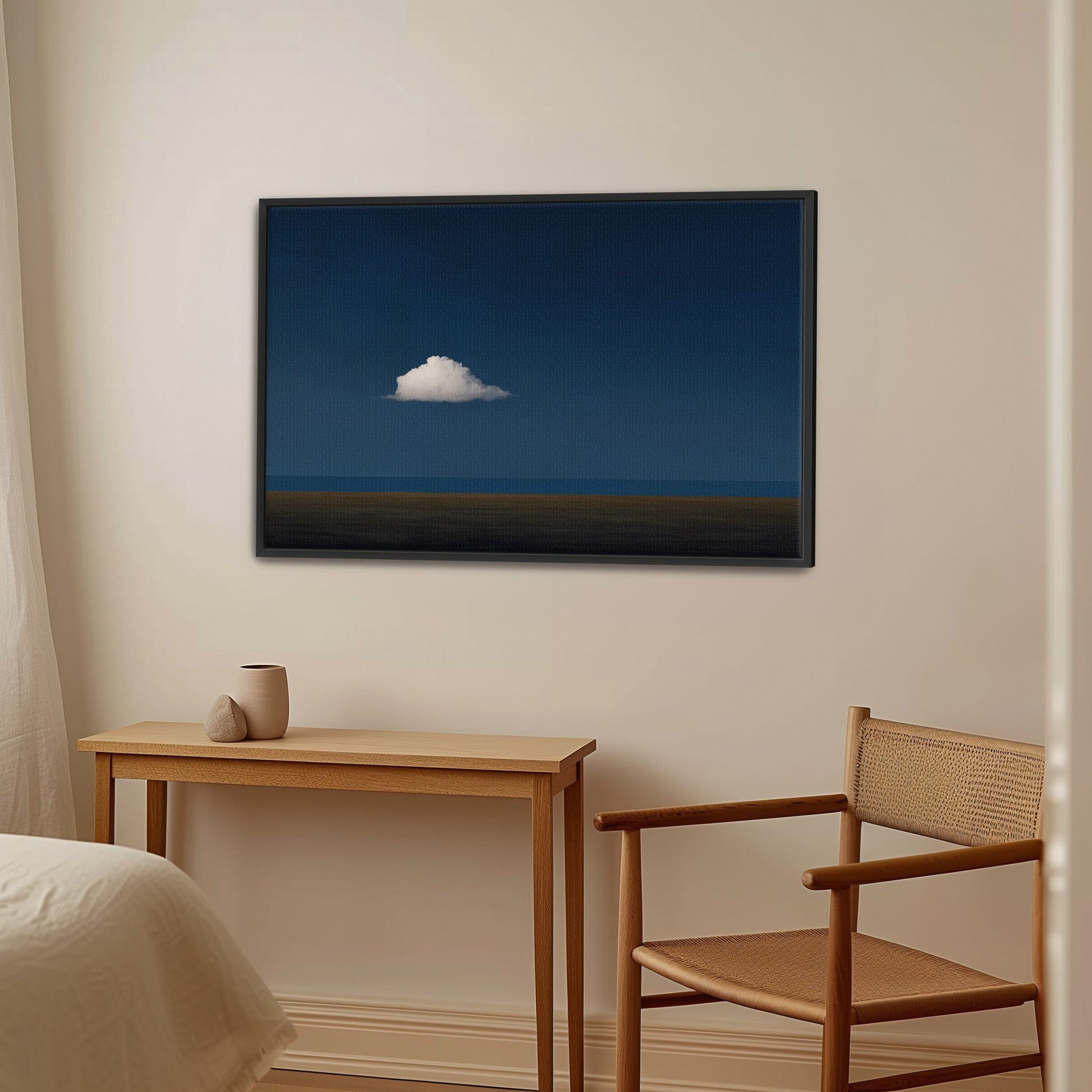 Nimbus canvas print featuring a solitary white cloud over a deep blue horizon in a modern minimalist interior