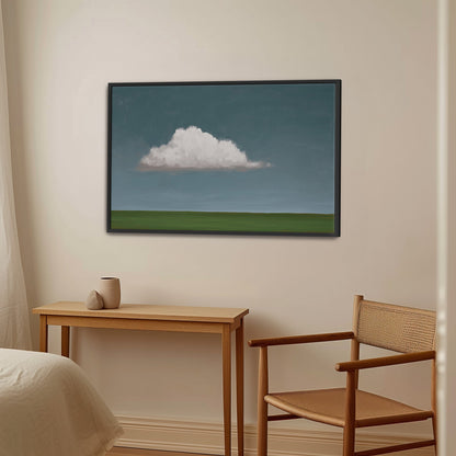 Eave canvas print with single cloud over green horizon in black frame hanging in minimalist room