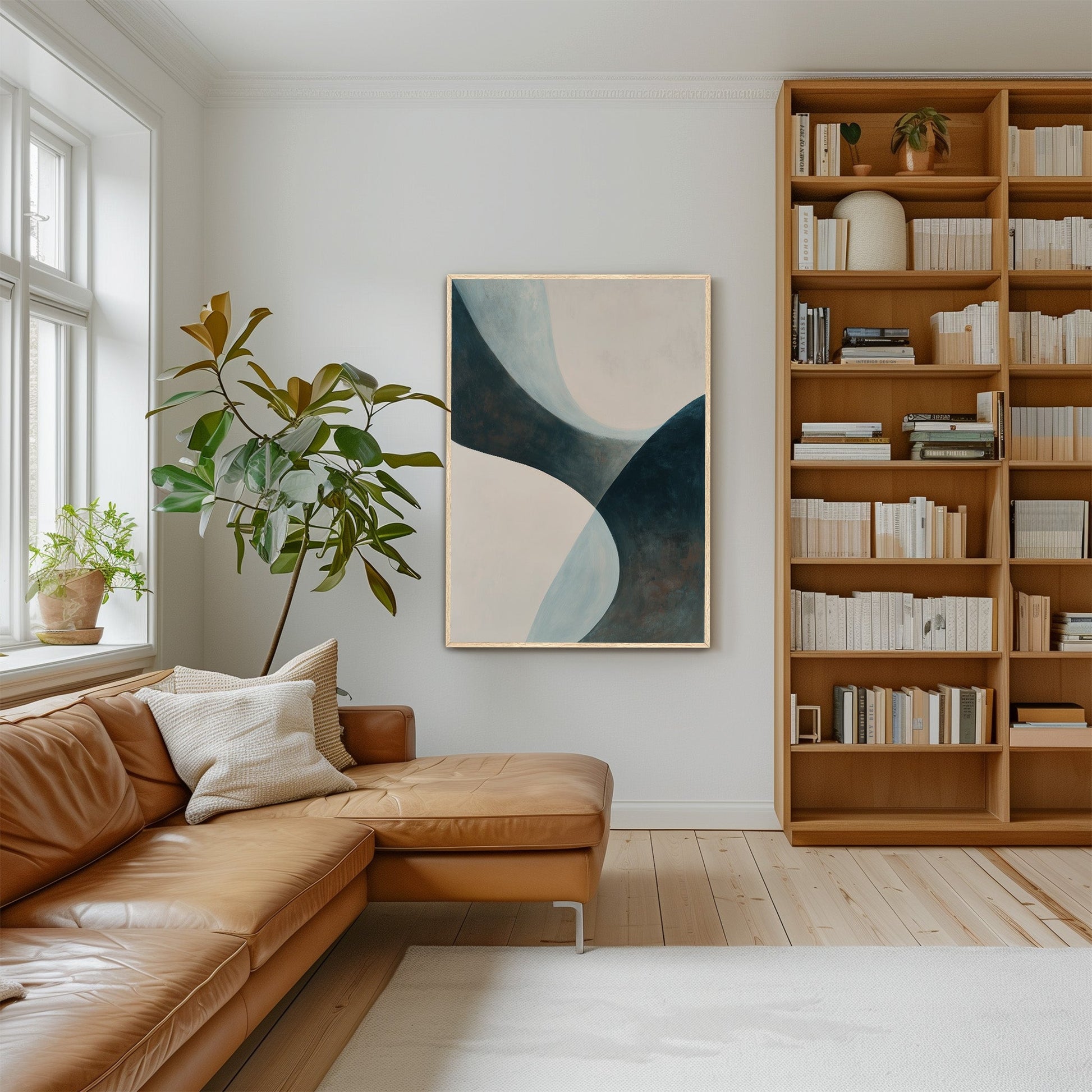 'Bend' Canvas Artwork abstract teal and cream curves on wall in modern living room with leather sofa and wooden bookshelf