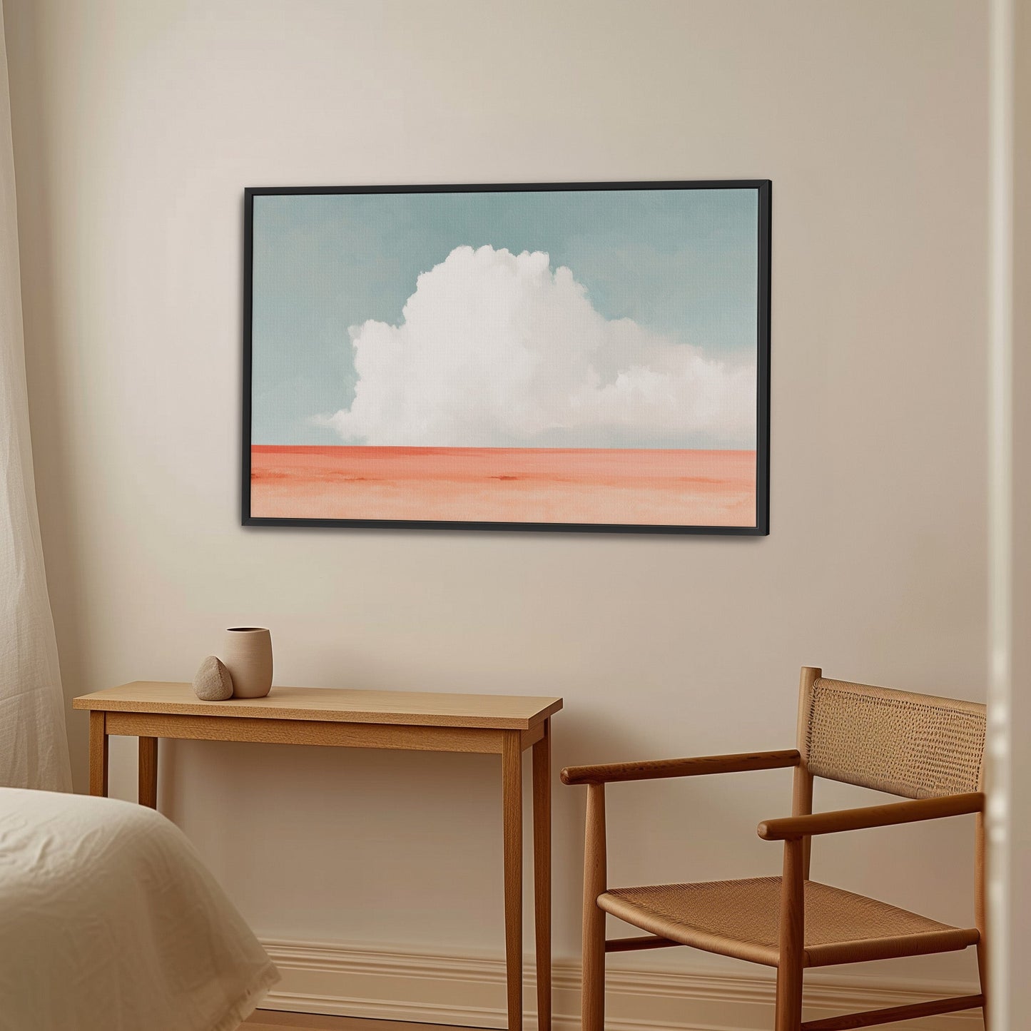 Aurea Canvas Wall Art featuring a white cloud over coral horizon in a black frame in minimalist room