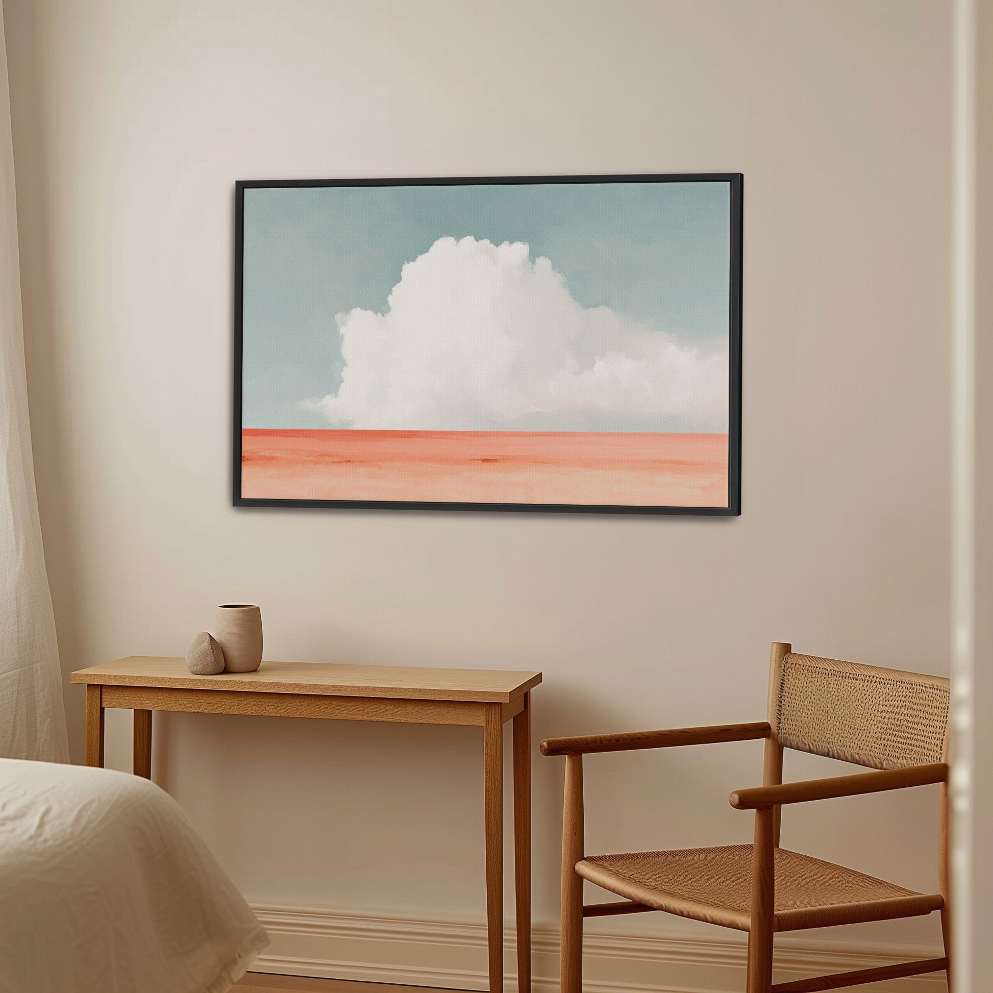 Aurea Canvas Wall Art featuring a white cloud over coral horizon in a black frame in minimalist room