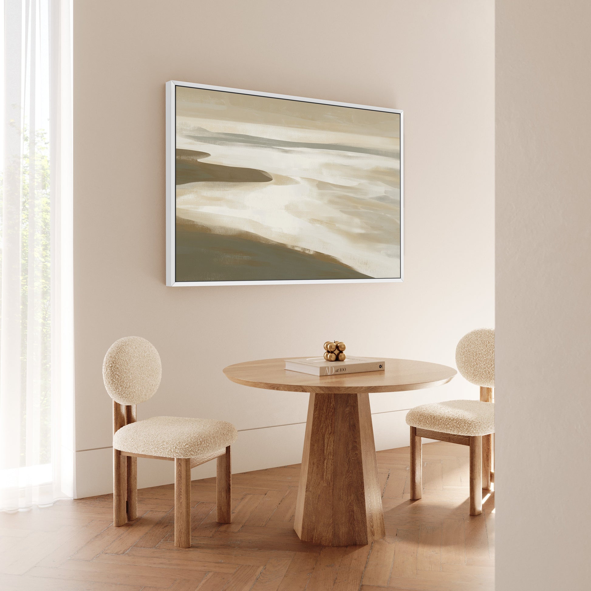 Emie Canvas Print coastal landscape in beige and olive tones framed and hung above wooden table with two chairs in a neutral room