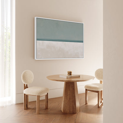 Minimalist Azure canvas print in sage and sand hues framed in white above wooden table with two beige chairs in modern room