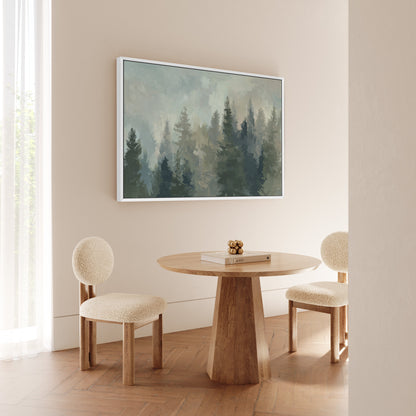 Ever Canvas Wall Art featuring misty forest in soft pine and sage tones, displayed in modern room with round wooden table and cream chairs