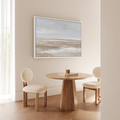 Barren Canvas Print minimalist landscape in taupe and cream tones framed in white hanging above a wooden round table with two beige chairs in a modern neutral dining room