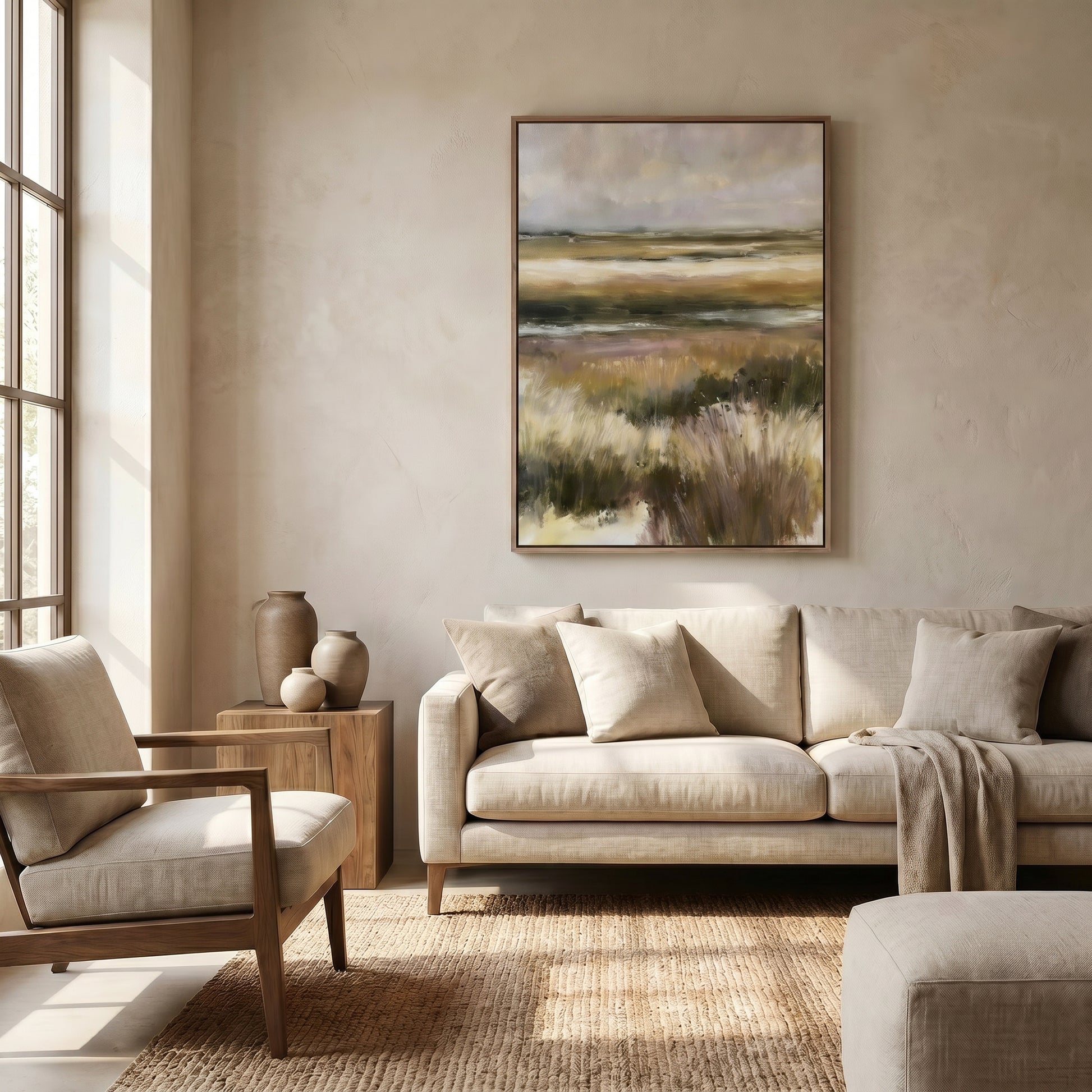 a serene living room with a large landscape painting hanging on the wall, a beige sofa, a wooden side table, and a large window that allows natural light to fill the space.