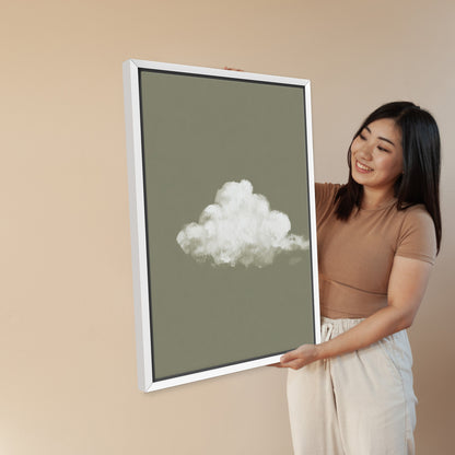 Woman holding Trace canvas print featuring a single white cloud on muted sage background with white frame