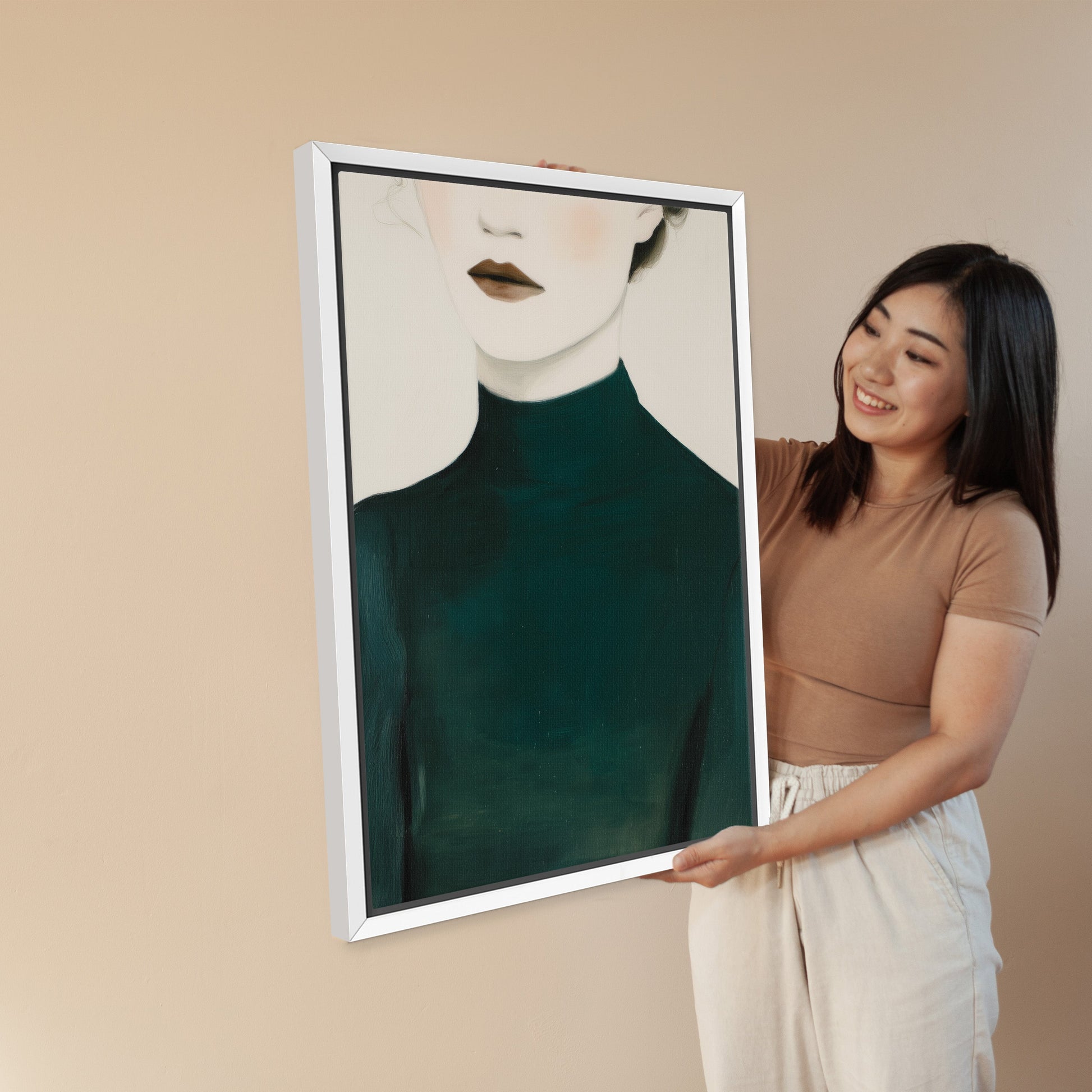 Woman holding Poise canvas print featuring faceless figure in deep emerald turtleneck with soft skin tones and minimalist design