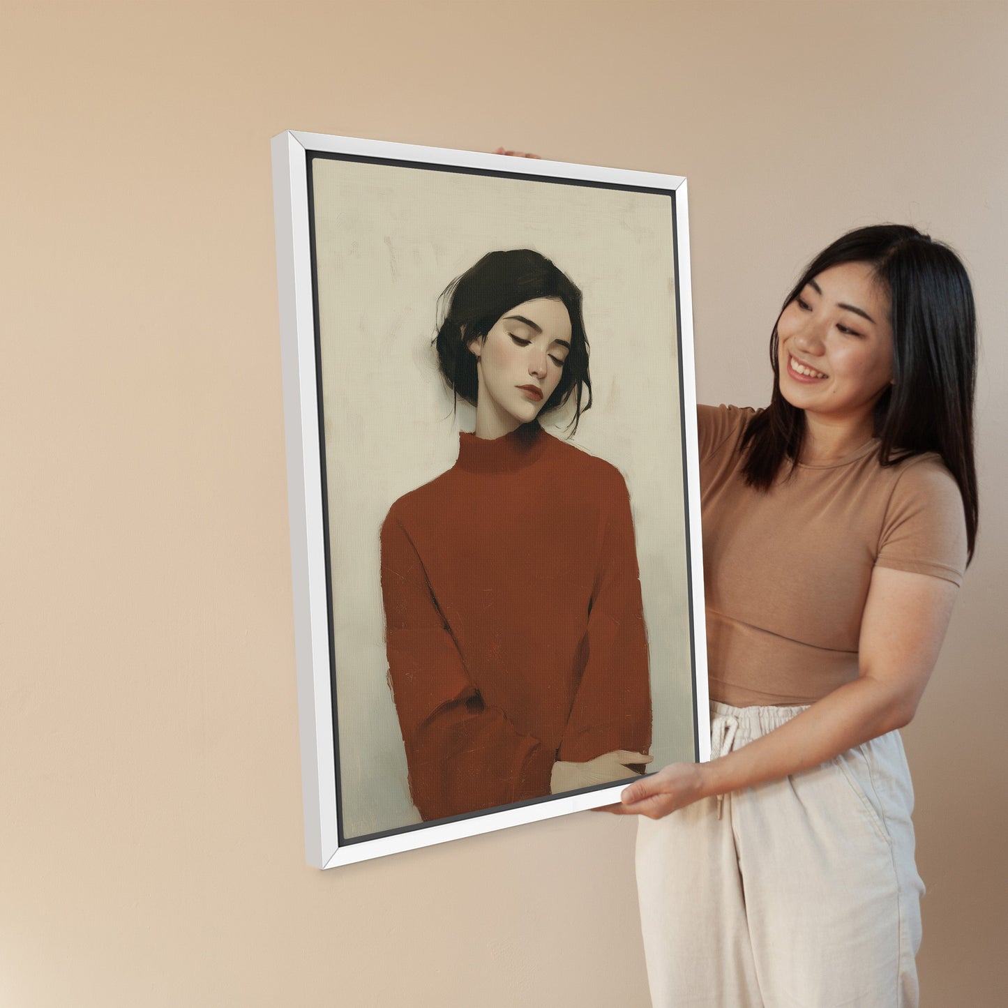 Madi canvas wall art of serene woman in deep red sweater with soft, muted tones in a white frame held by smiling woman