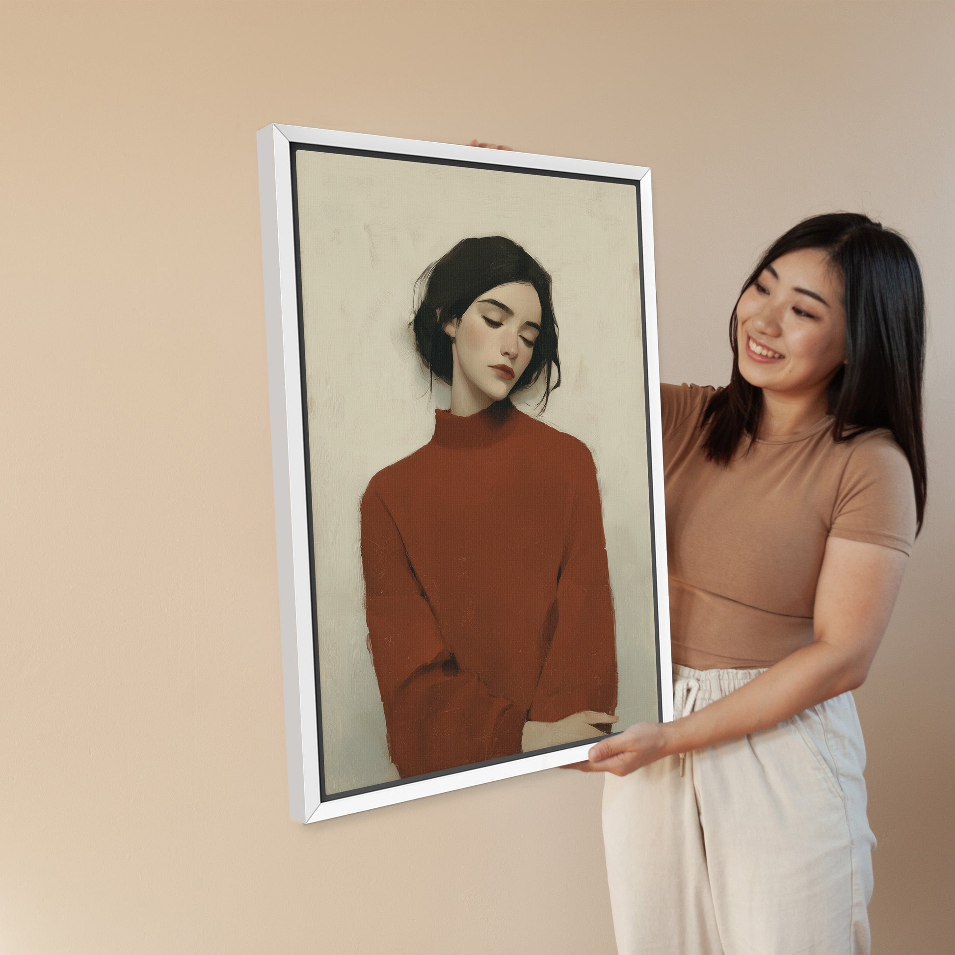Madi canvas wall art of serene woman in deep red sweater with soft, muted tones in a white frame held by smiling woman