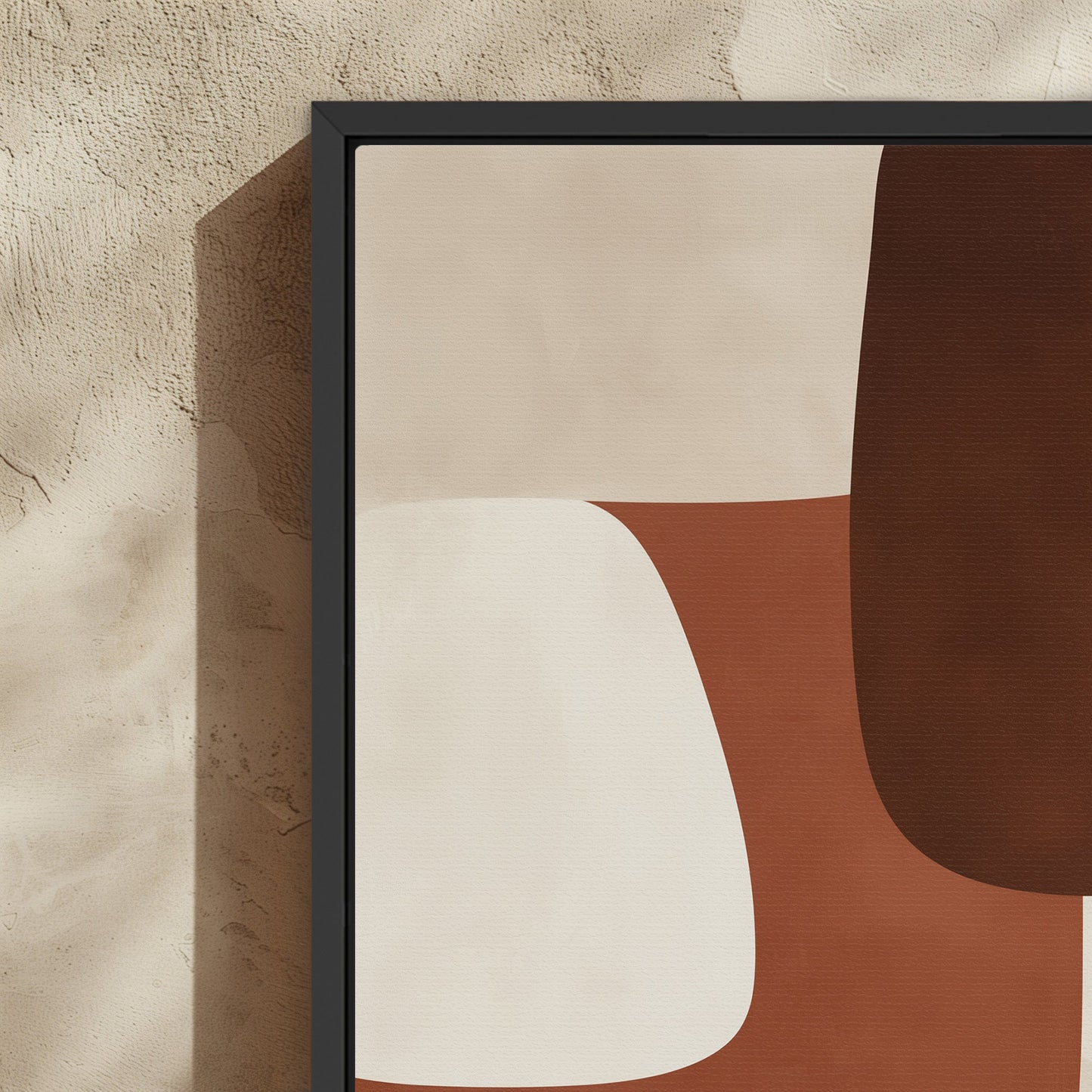 Abstract Formation Canvas Print with sienna, ivory, and espresso shapes in a black frame on textured wall