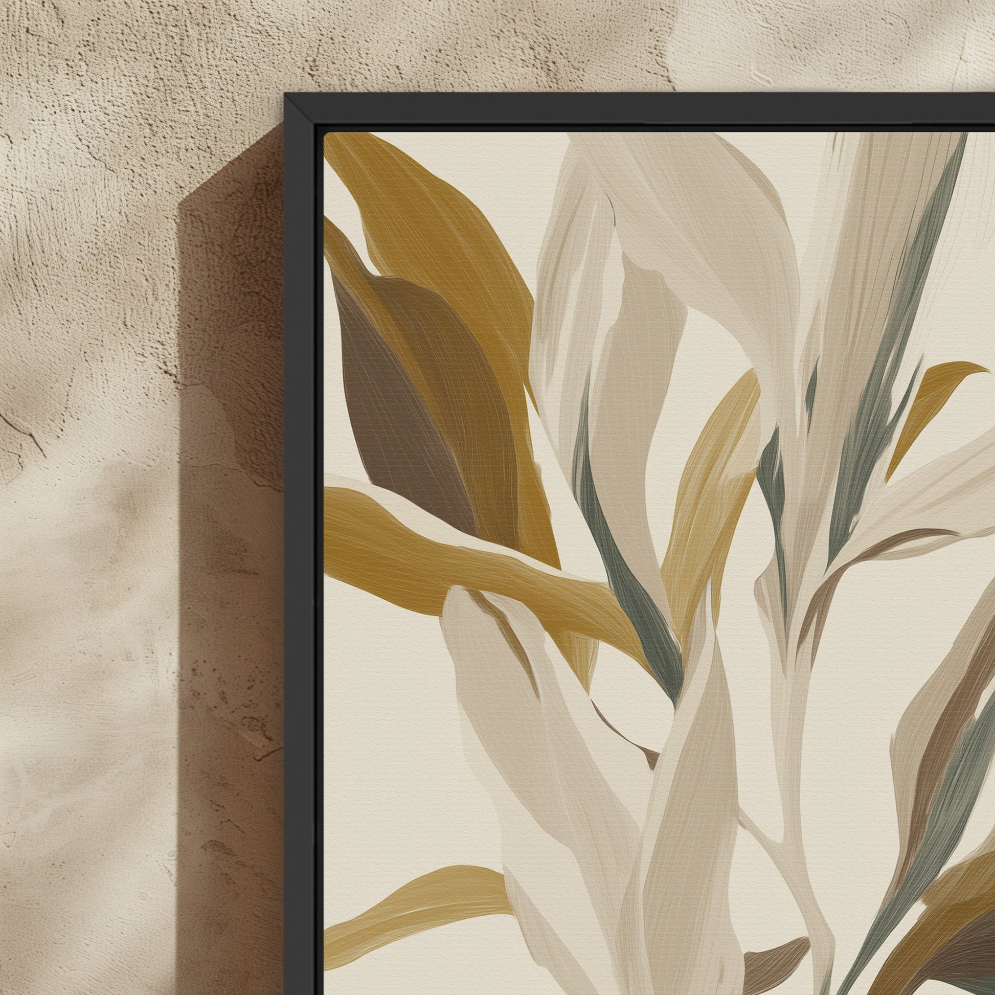 Lilt Canvas Print featuring painterly leaves in earthy golds, taupes, and sage with a black frame on textured wall.