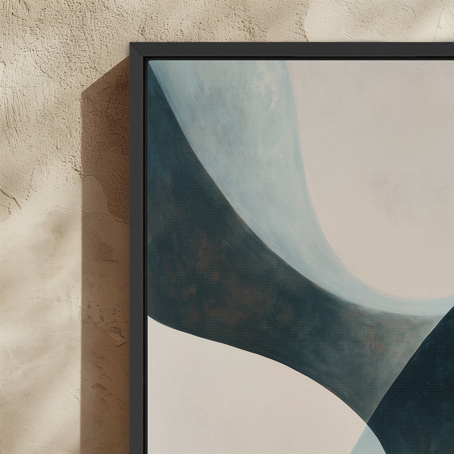 Close-up of 'Bend' canvas artwork featuring soft teal and cream curves in a black frame on textured beige wall