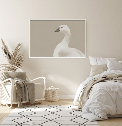 Grace Canvas Print featuring a white bird in soft cream and beige tones, framed and displayed in a modern minimalist bedroom.