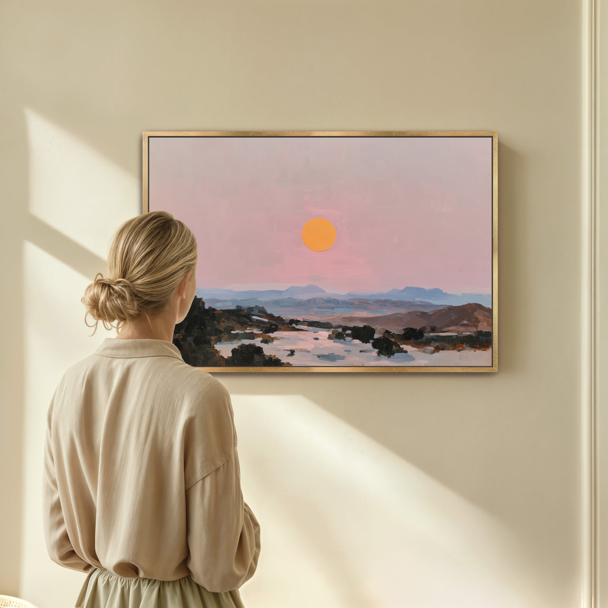 A woman stands in front of a painting, gazing at the landscape depicted in the artwork.