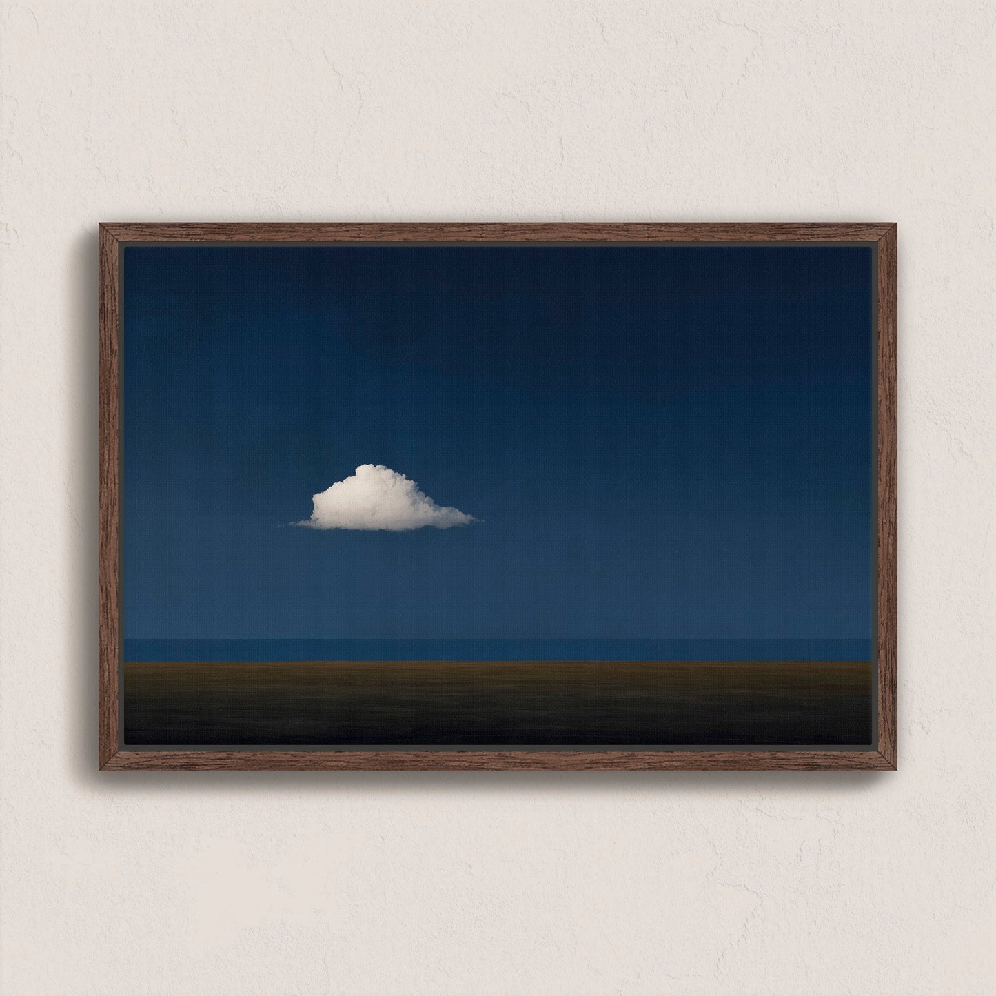 Nimbus canvas print of a solitary white cloud over a dark blue horizon in a walnut wood frame