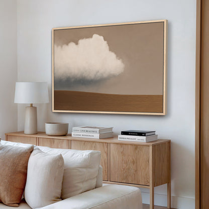Aerie Canvas Print minimalist cloud landscape in warm taupe and ivory tones above muted earth horizon in wooden frame hanging in modern living room