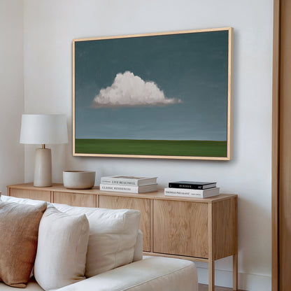 Eave Canvas Print featuring a single cloud over green horizon in muted tones with natural wood frame in modern living room