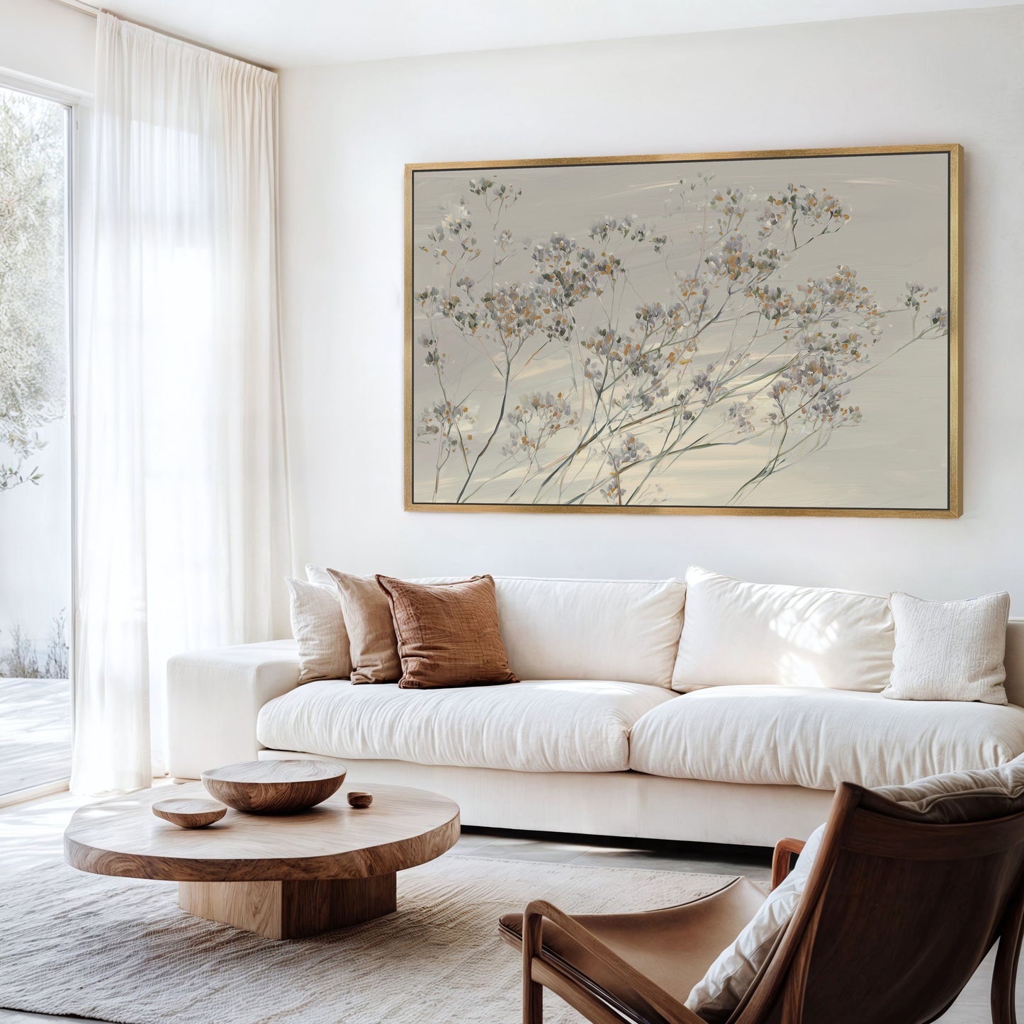 Breeze wall art of delicate wildflowers in muted tones framed in wood above white sofa in modern living room