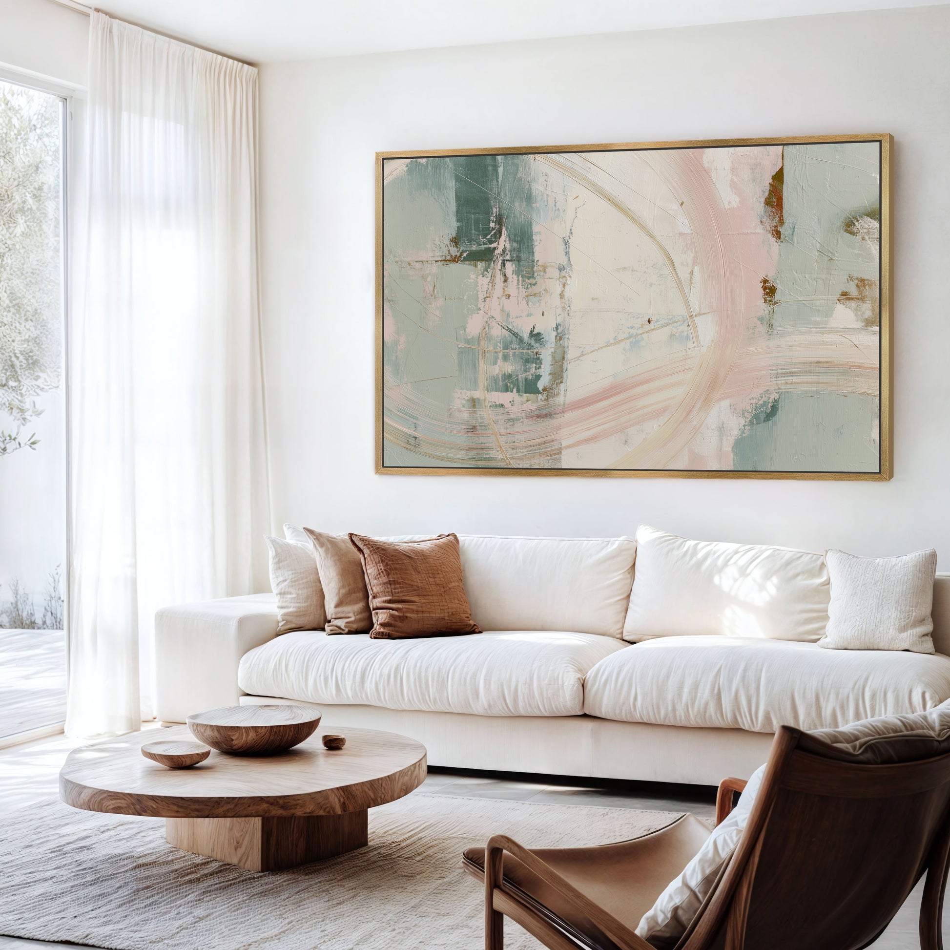a modern living room with a large abstract painting on the wall, a white sofa, a wooden coffee table, and a brown leather armchair.