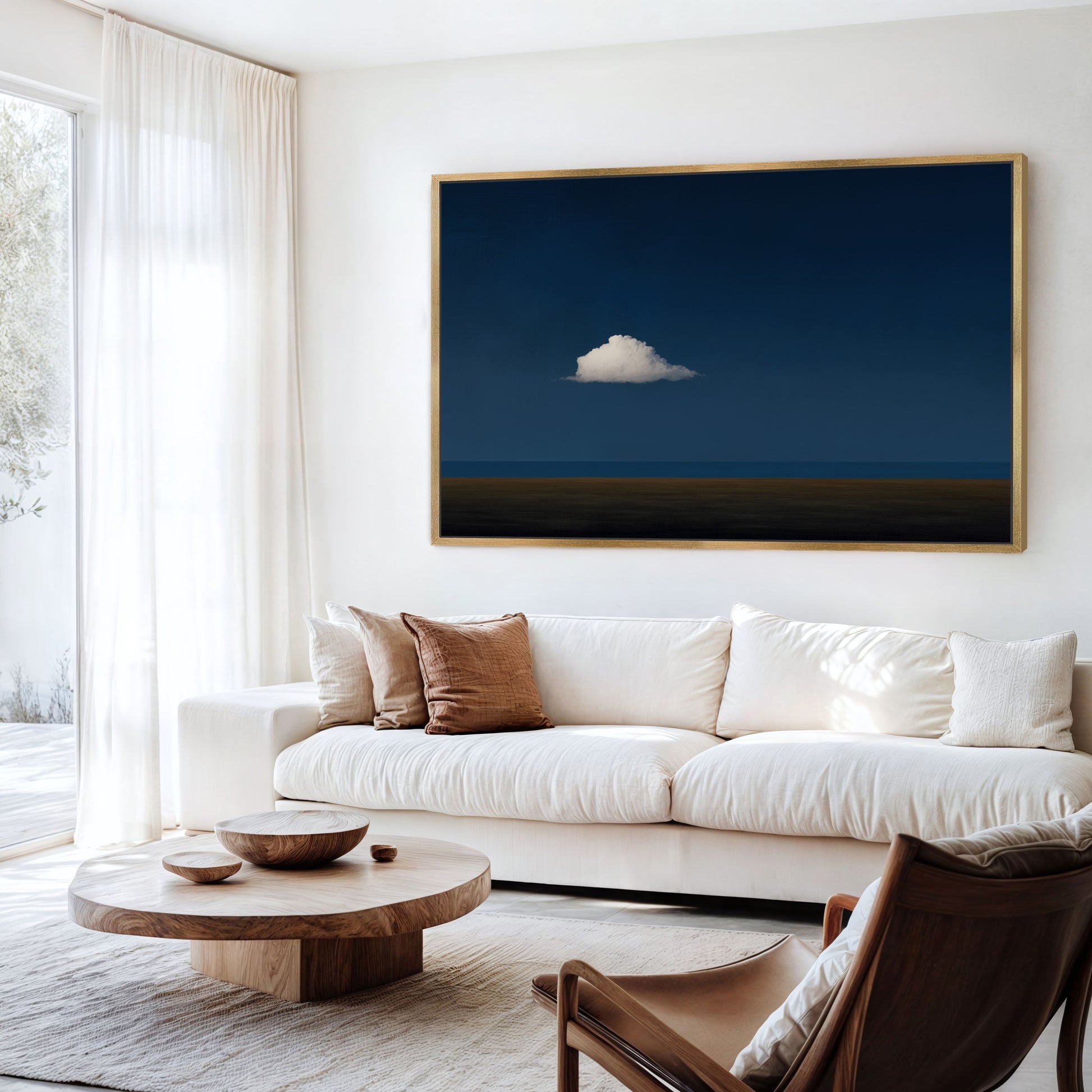 Nimbus Canvas Print showing a solitary white cloud over a deep blue horizon in a modern living room.
